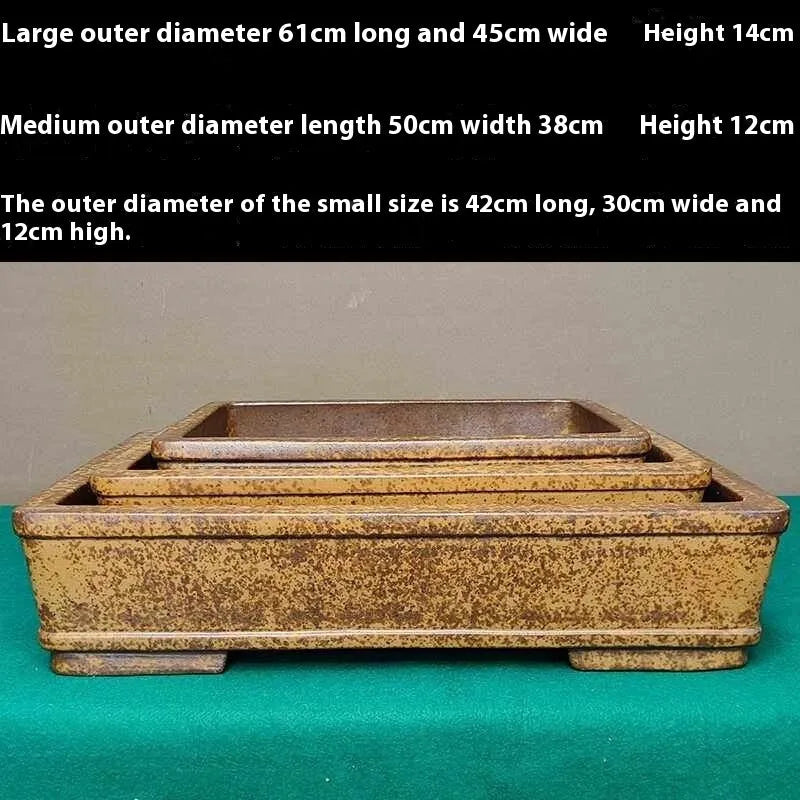 Straight shallow rectangular Yixing purple sand flowerpot for plants on a surface.