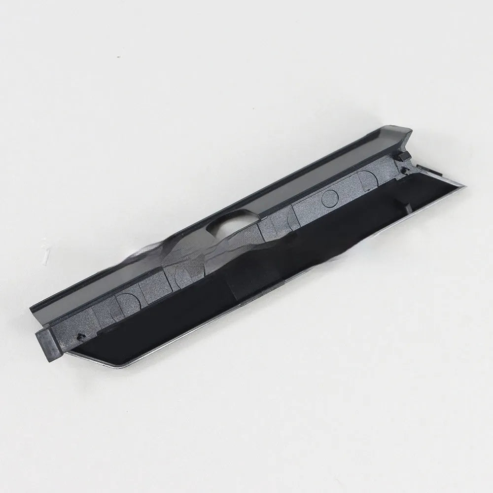 A black plastic hard drive bay cover for a 3.5-inch slot, shown alongside a white version.