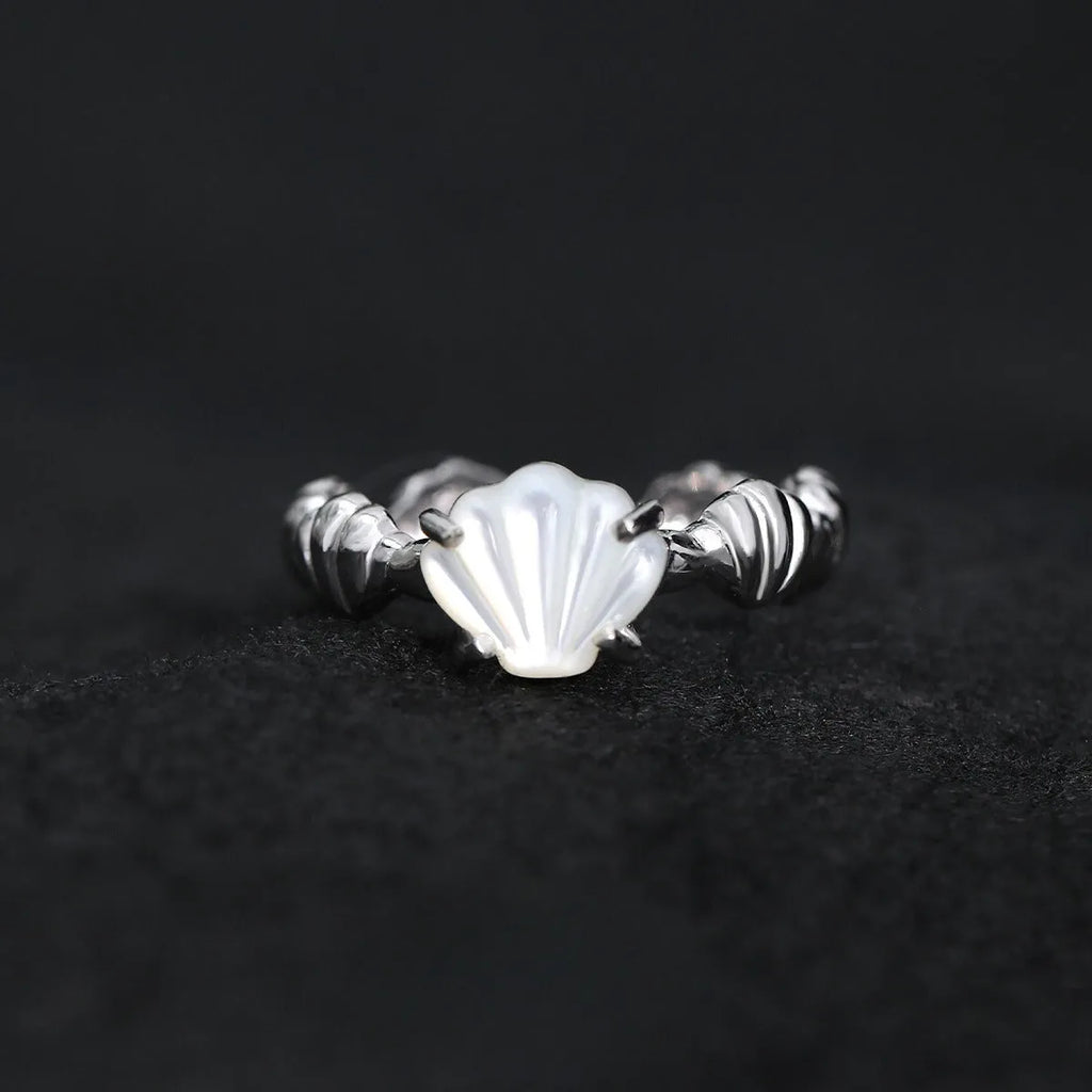 Silver adjustable ring with a white shell and tiger eye stone design in electroplated finish