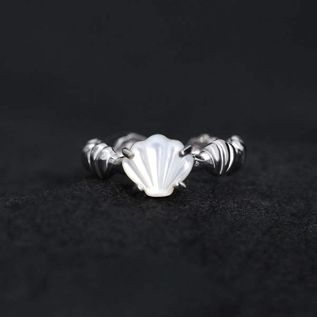 Silver adjustable ring with a white shell and tiger eye stone design in electroplated finish