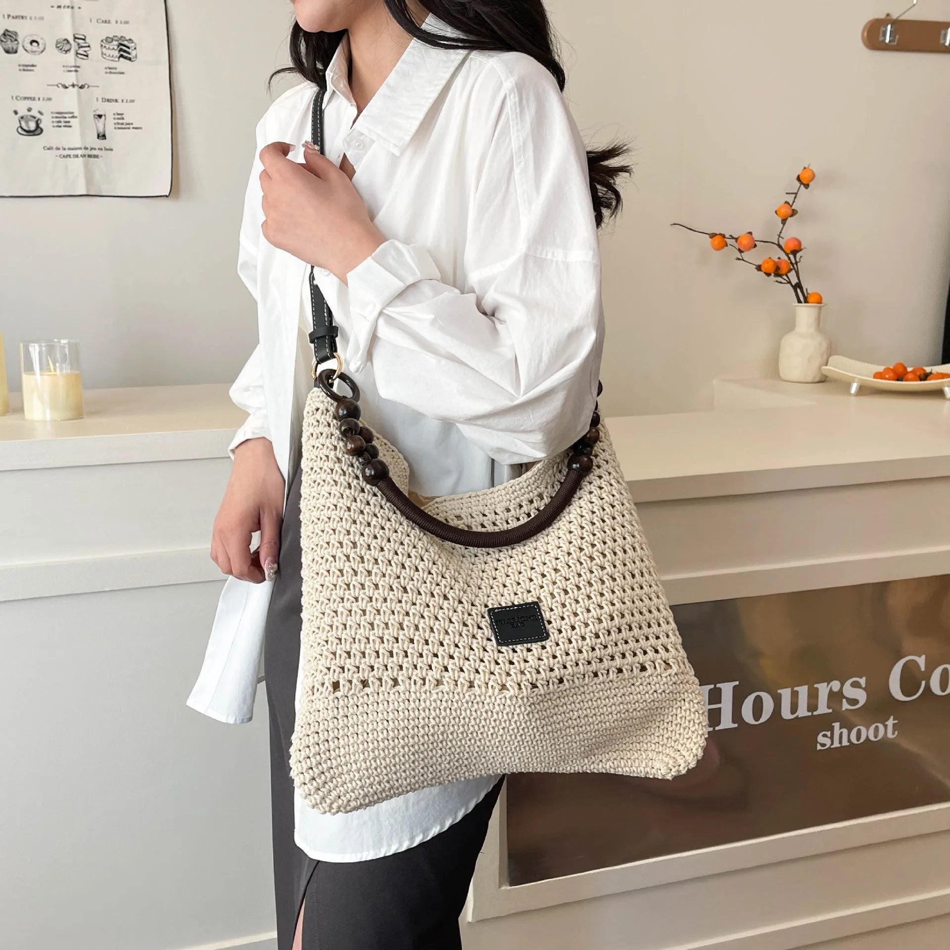 Large knitted tote beach bag with bucket shape and contrast stitching in black or brown colour options