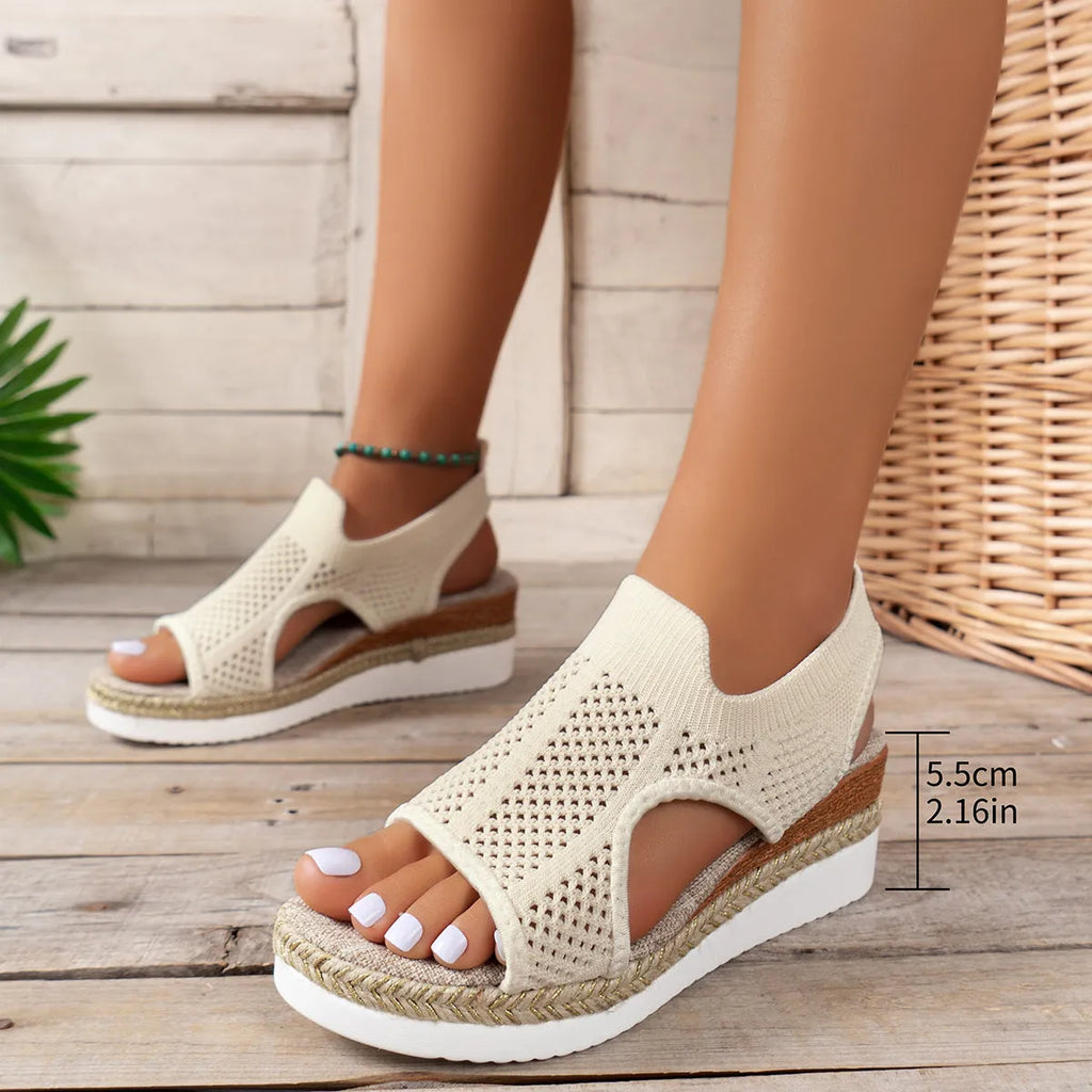 Women's hollow wedge peep-toe sandals in beige with patent leather upper and breathable mesh, side view