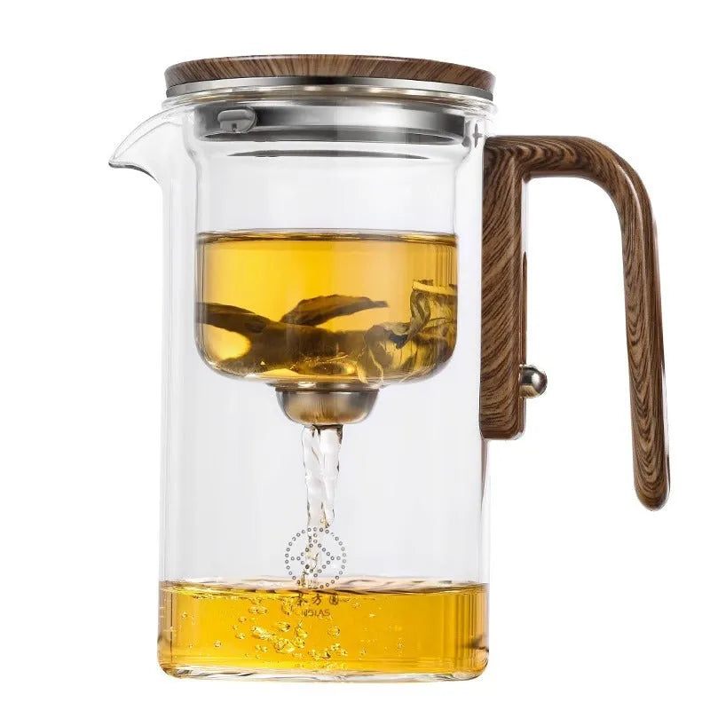 Glass teapot with wooden handle showing magnetic separation button and inner filter basket.