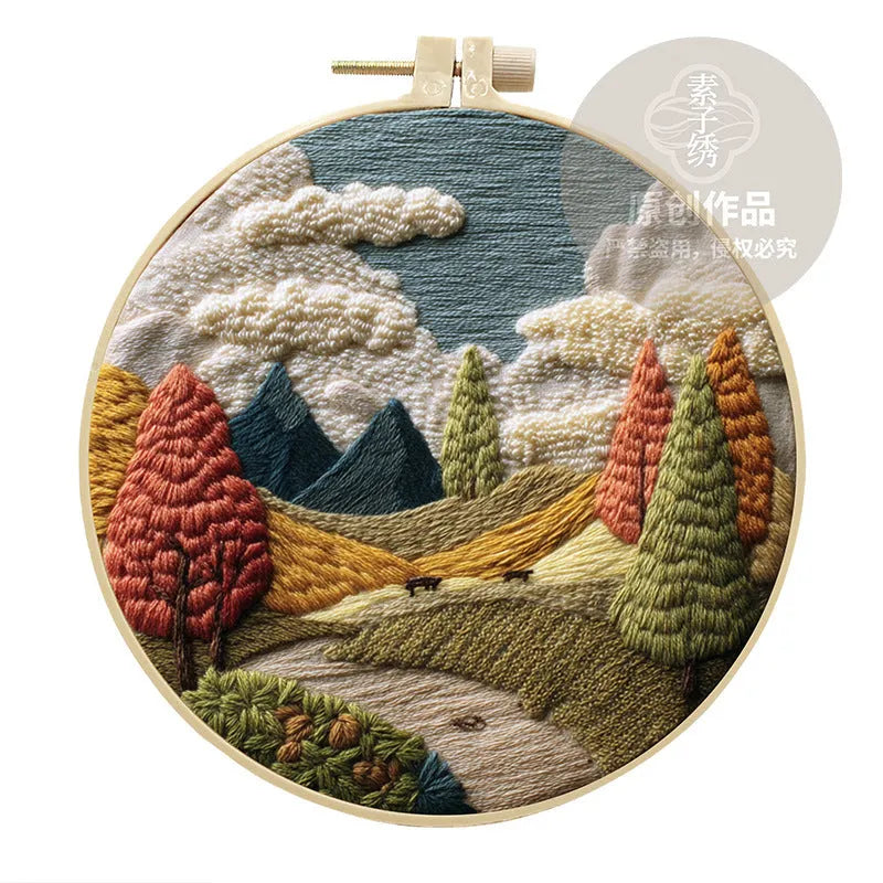 Embroidery DIY kit with cotton linen fabric, bamboo hoop, threads, and needles for landscape designs.