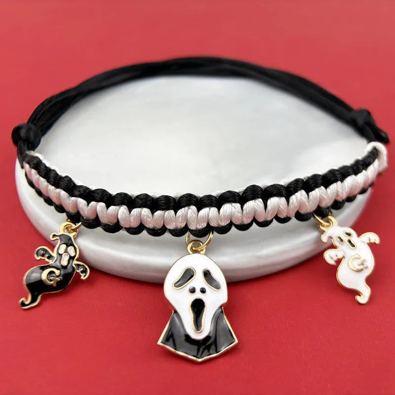 Zinc alloy Halloween charm on a pet collar, showing geometric pattern and clip.