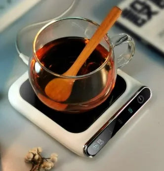 Black USB coffee mug warmer on a desk with a mug, showing three-speed control and tempered glass top.