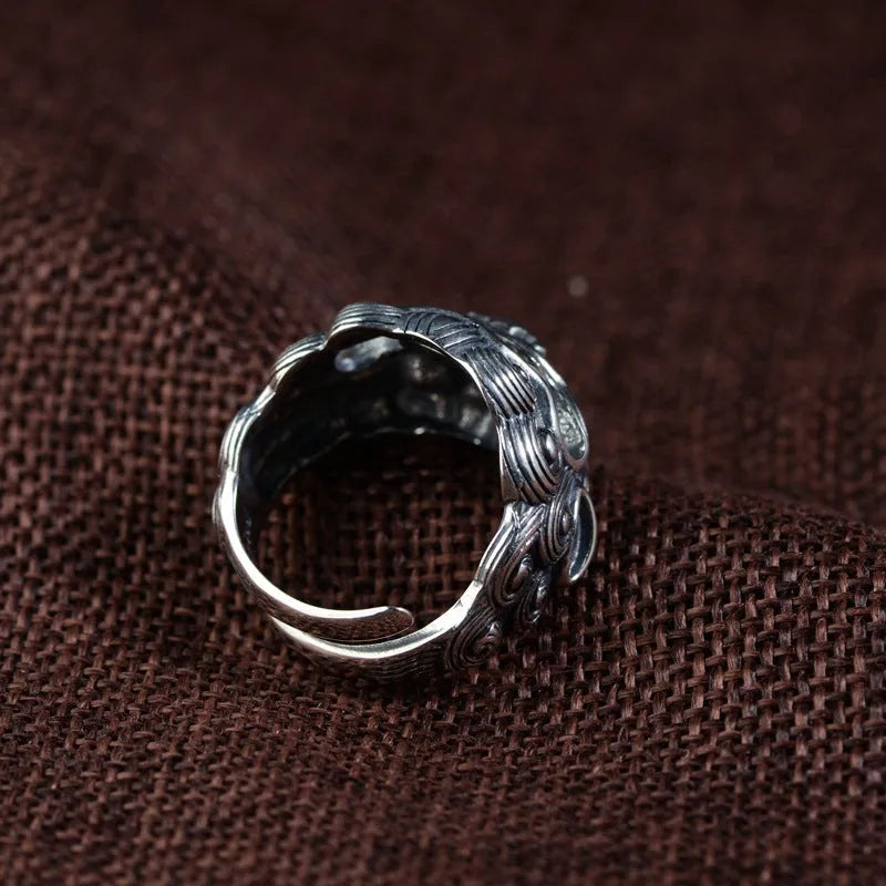 Silver open ring with a jibeast pattern, animal zodiac modelling, and a personalised diamond element.