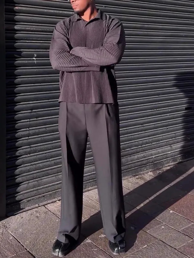 Black men's long-sleeved casual top with a pleated front detail, shown in a regular fit.