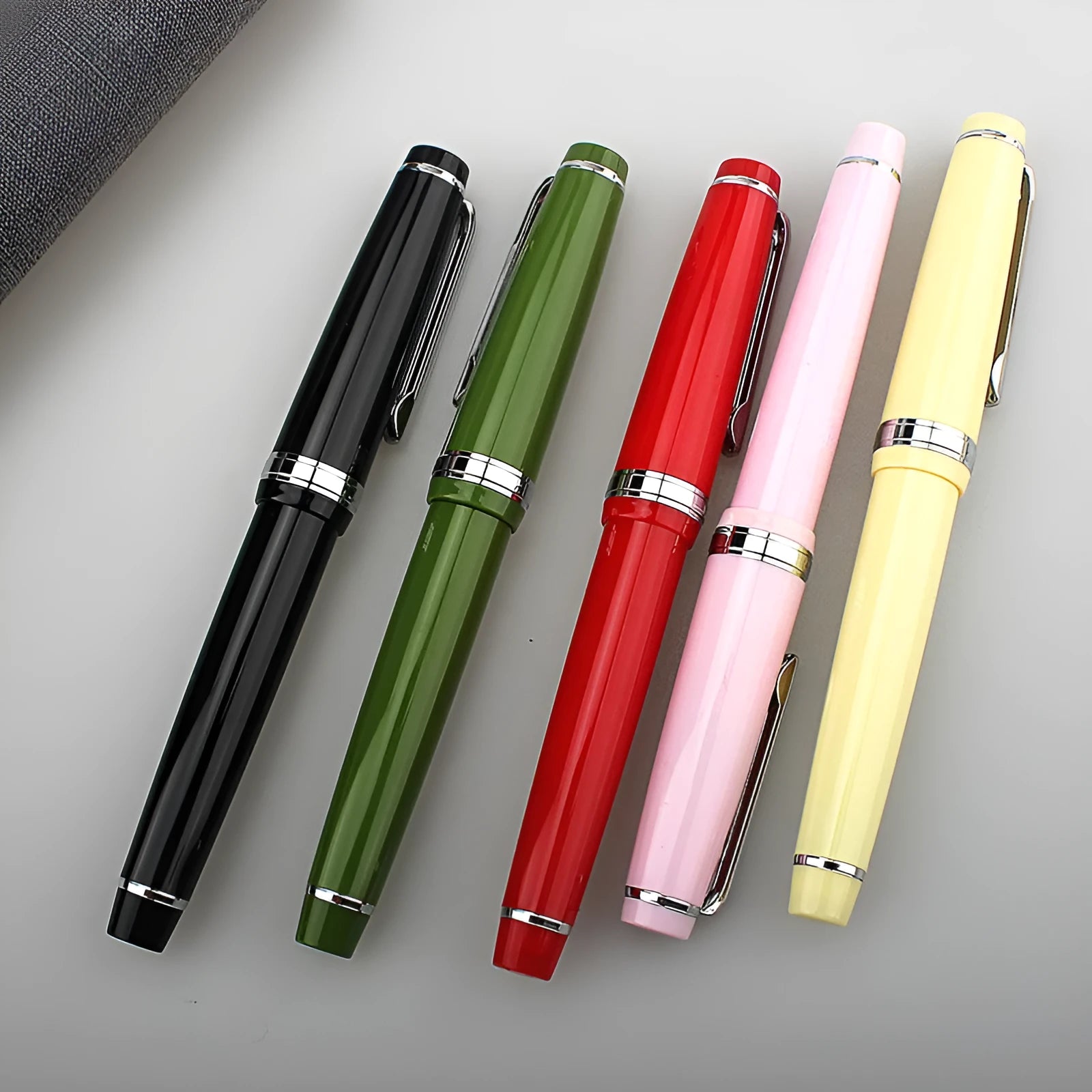 Resin fountain pen with stainless steel nib, shown in black with gold clip option.