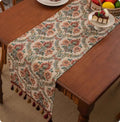 Retro style polyester table flag with long handwoven tassels on a wooden table.