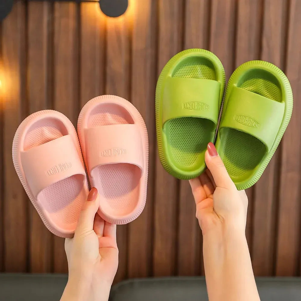 Colourful children's EVA slippers with a textured non-slip sole, shown in blue, green, orange, pink, and yellow.