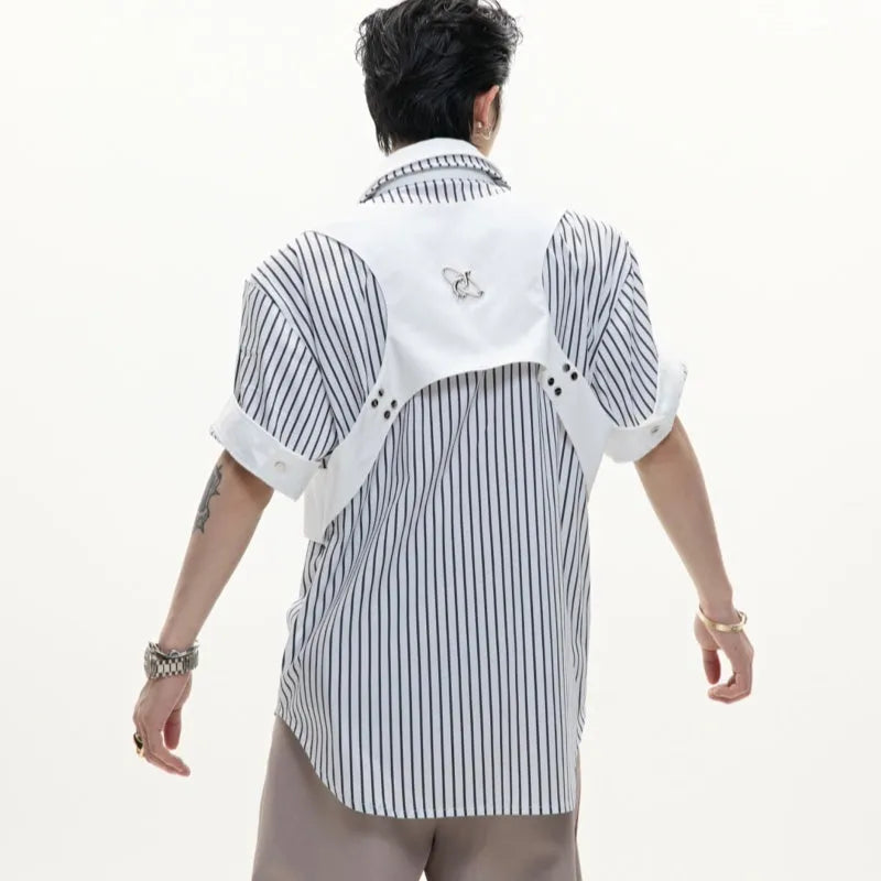 Man wearing a black and white striped short sleeve shirt with a distinctive double lapel collar design.