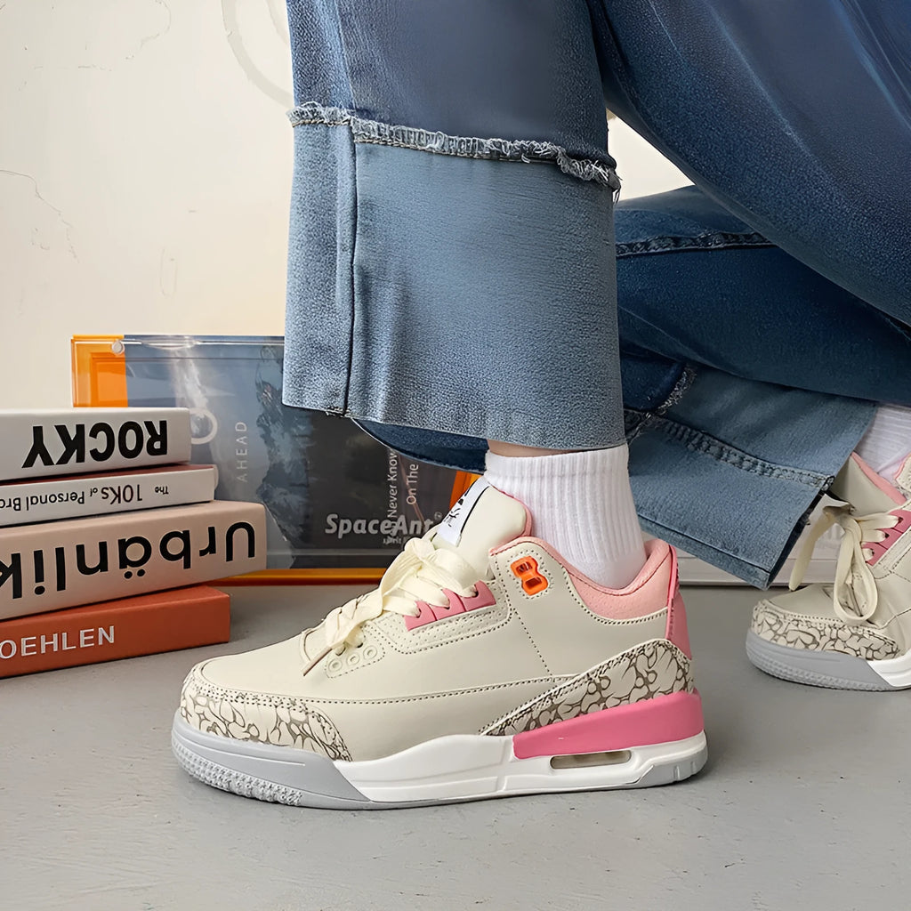 Pink lightweight basketball running shoe with microfiber upper, leather stitching, rubber sole and mesh lining