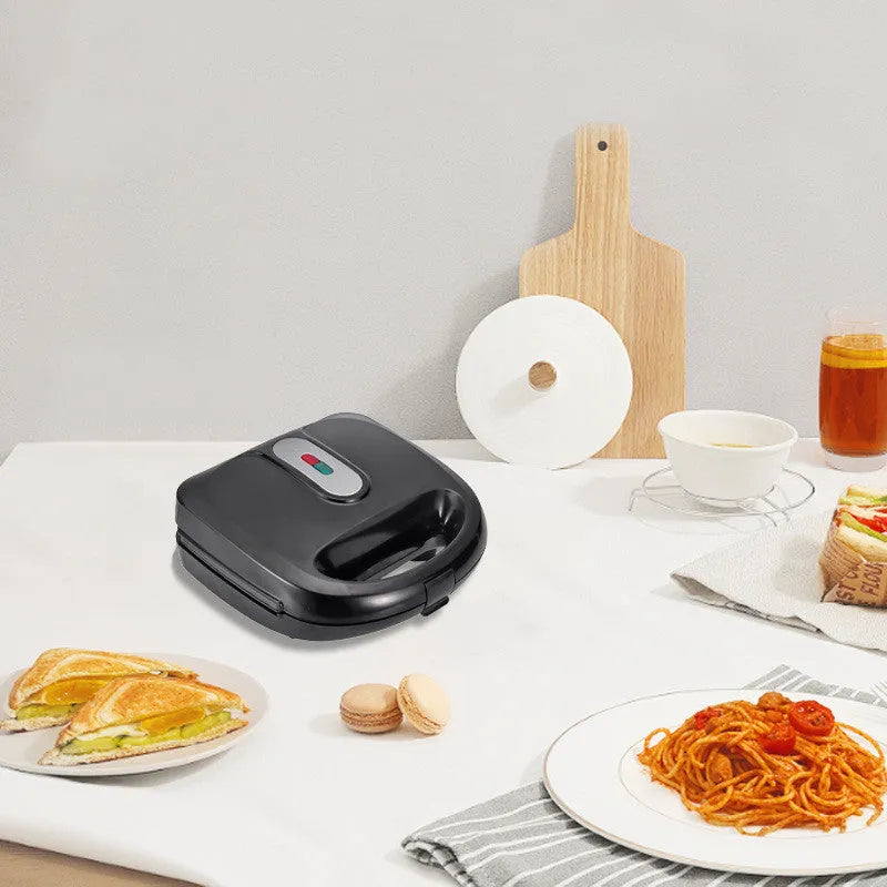 Black electric sandwich pan with brushed stainless steel top cover showing non-stick cooking surface