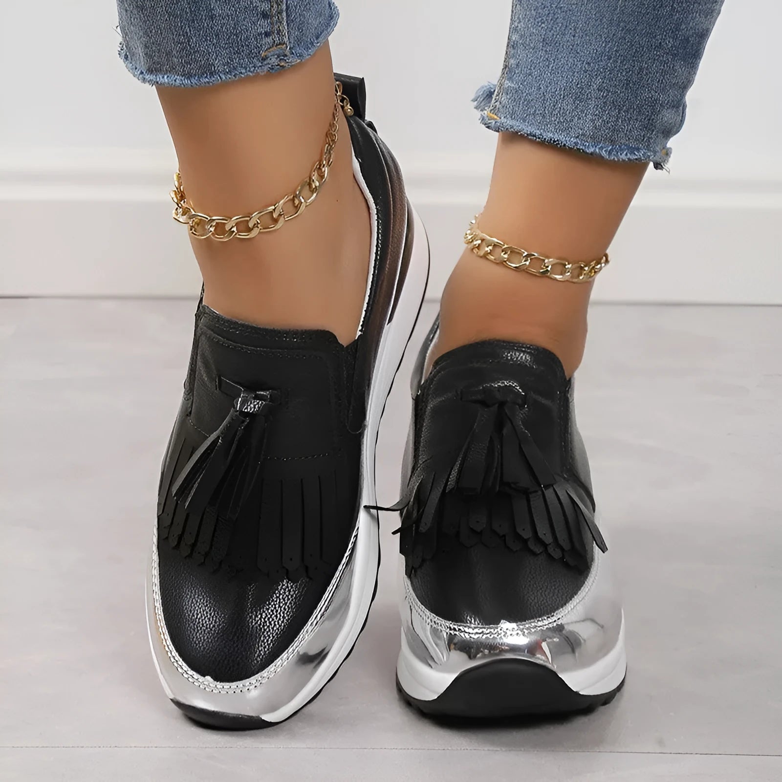 Women's black casual platform shoes with a muffin wedge heel and a decorative tassel.