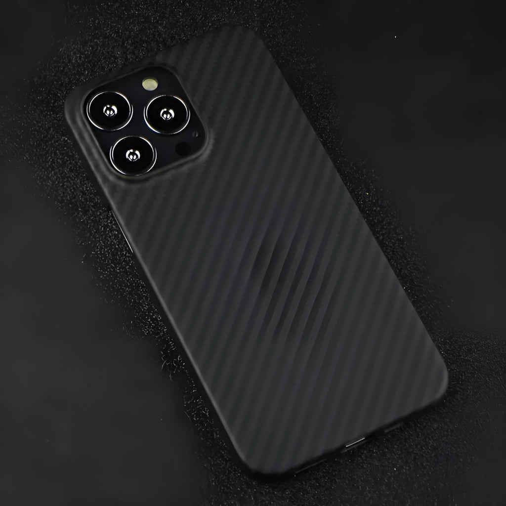 Matte black Kevlar fibre iPhone case with textured back, shown next to an iPhone.