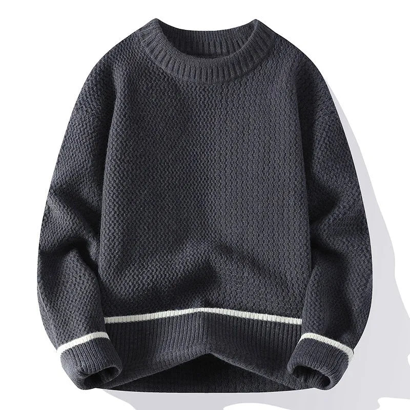 Man wearing a grey loose fit round neck long sleeve pullover sweater