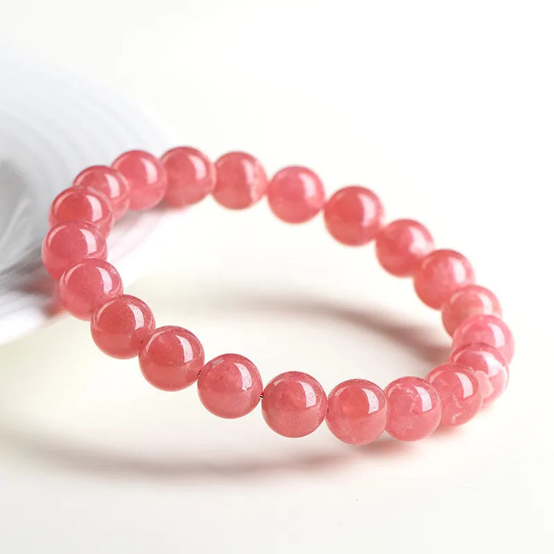 Geometric red crystal women's bracelet with a longevity lock fastening on a wrist.