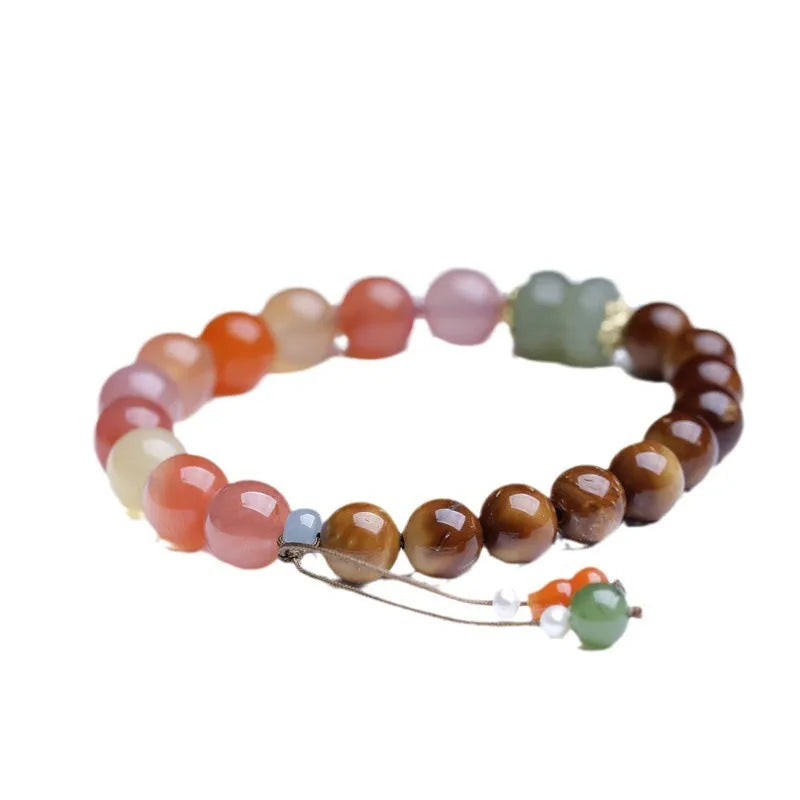 Women's agate bracelet with 8mm diamond-shaped persimmon-coloured beads on a wrist.