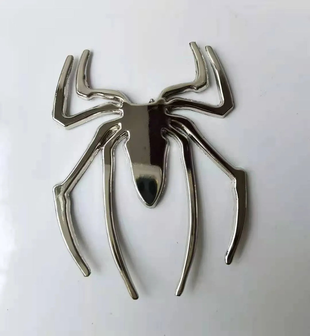 Three-dimensional zinc alloy spider emblem sticker in gold, measuring 7cm by 5cm.