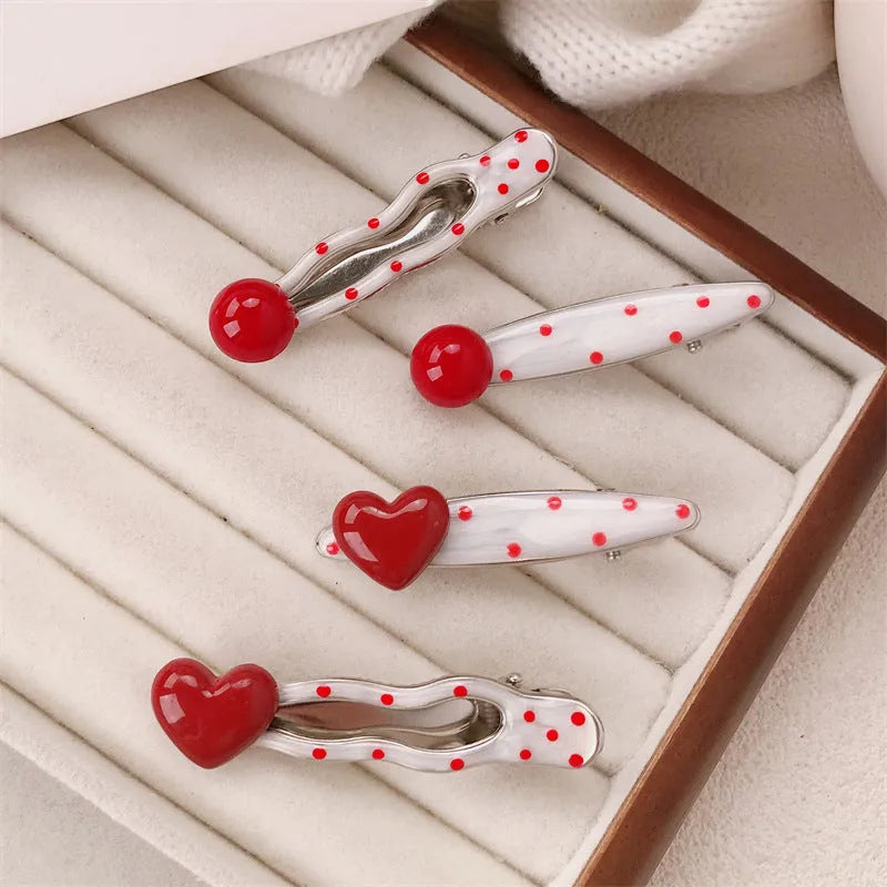Red love heart shaped barrette hair clip with retro white dot design on black background