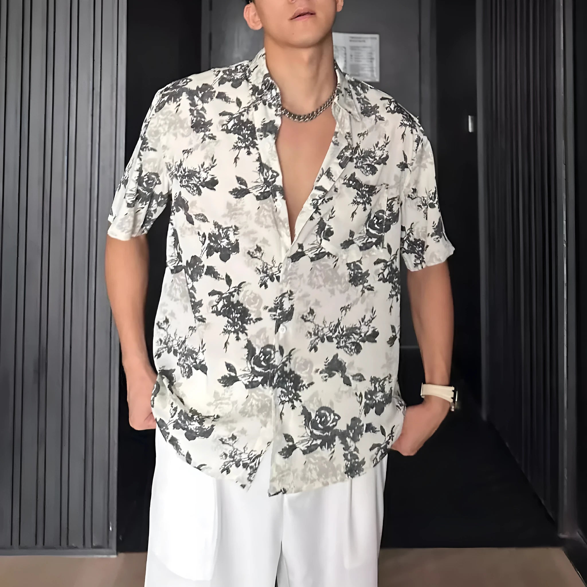 Black and white loose-fit floral printed short sleeve casual shirt on a hanger.
