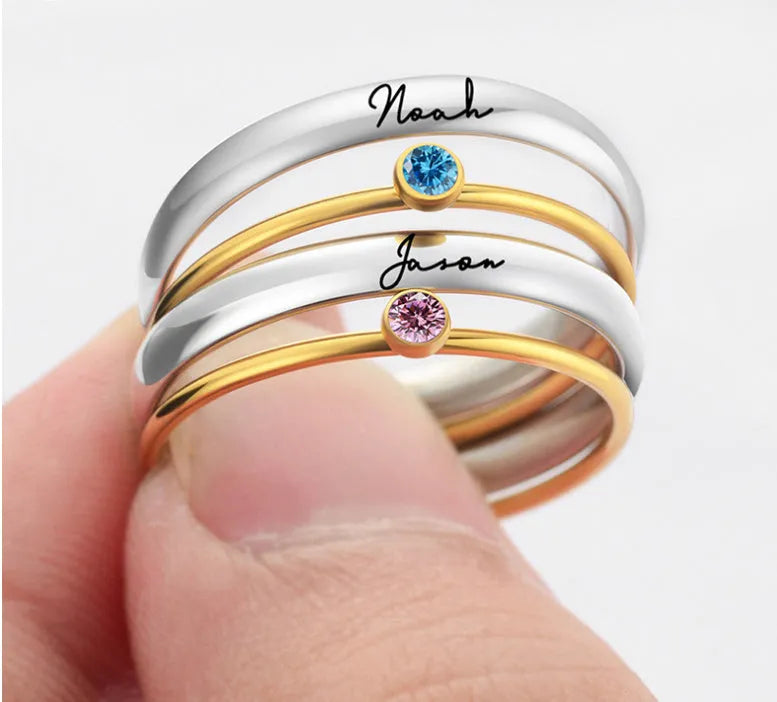 Geometric titanium steel ring with engraved December birthstone design on a hand.