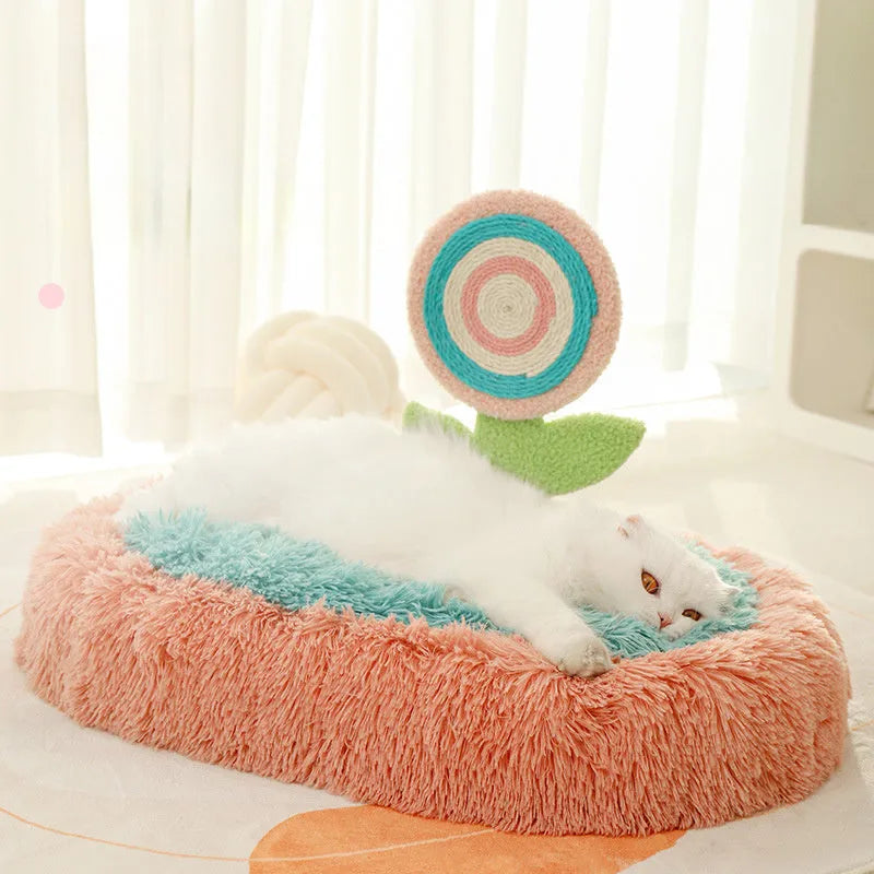 Pink plush elliptical cat bed with integrated lollipop-shaped bolster and removable cover