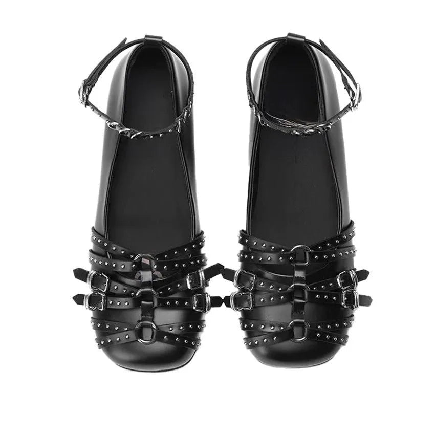 Women's black patent leather retro pumps with a square toe and buckle fastening on a low flat heel.