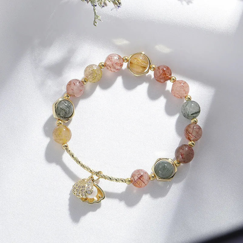 Colourful crystal shell bracelet with hair crystal detailing and red sealant flower shell accents