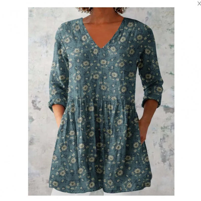 Women's loose-fitting dress with a wave print pattern, wide waist, and three-quarter length sleeves.