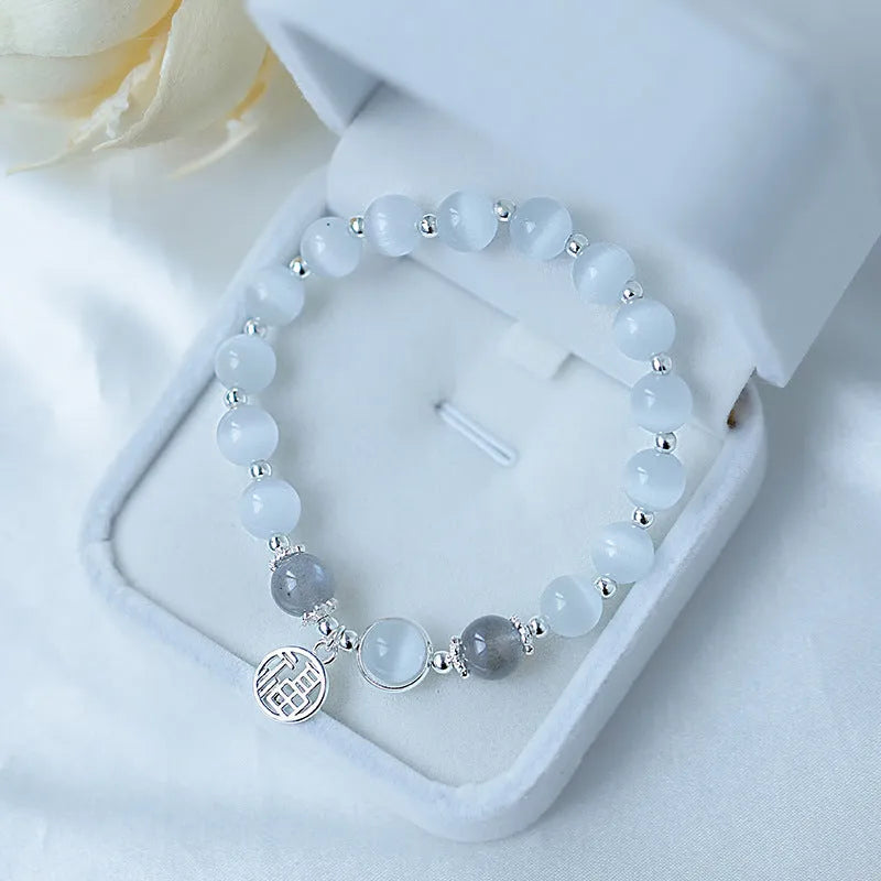 Women's beaded bracelet with diamond-shaped cat's eye opal stones in multiple colour options on a wrist.