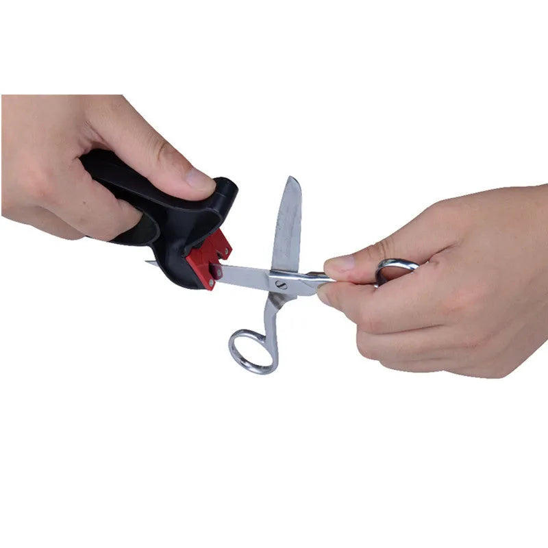 Black handheld knife and scissor sharpener with ergonomic grip on white background