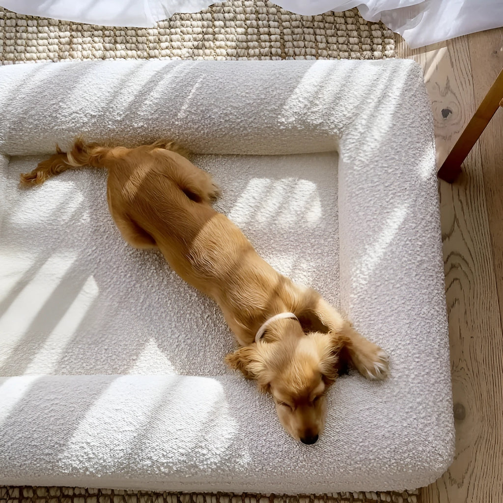 Beige rectangular cloth dog bed shown in medium size on a floor.