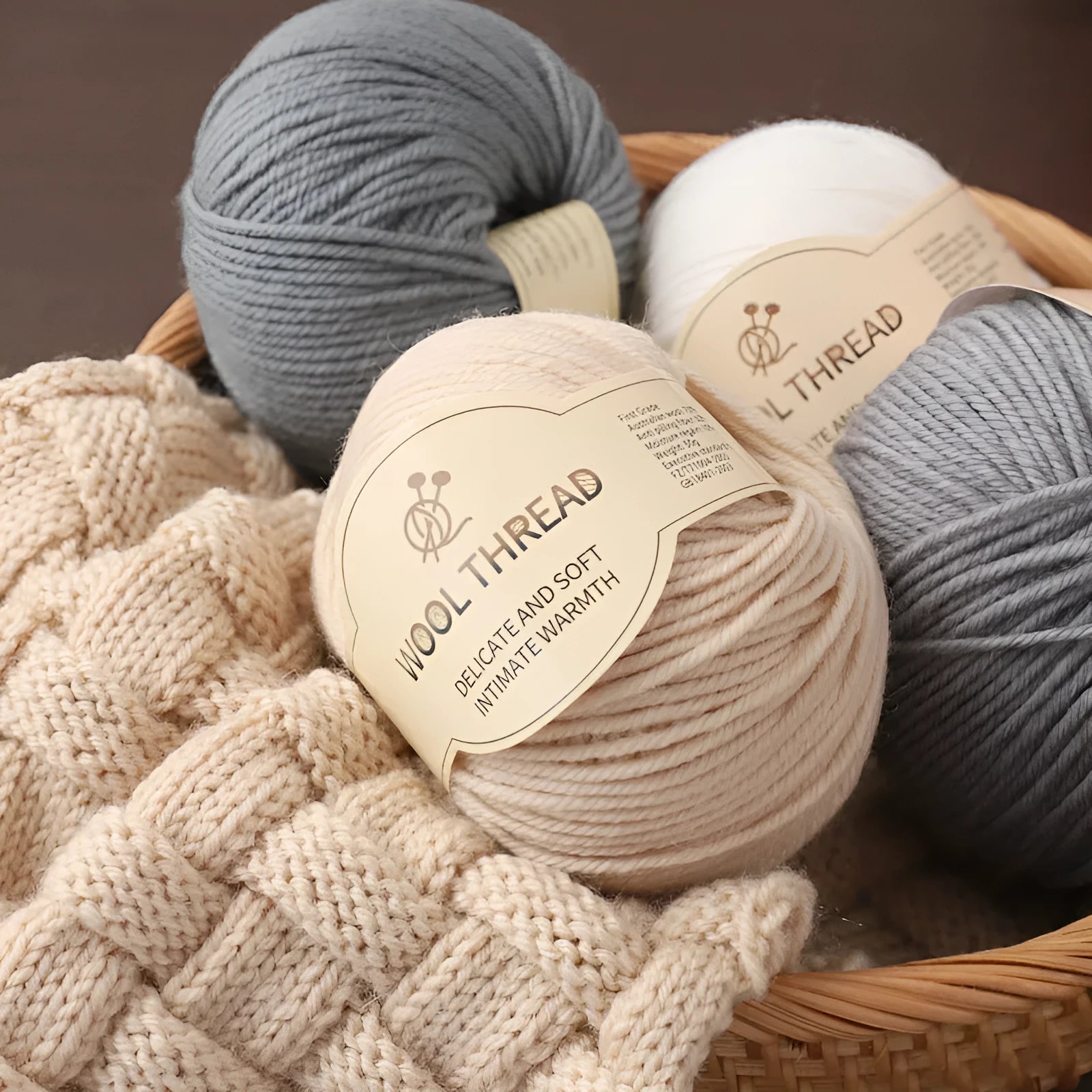 Roll of hand-knitting wool threads in various colours for baby garments with 10 knitting needles