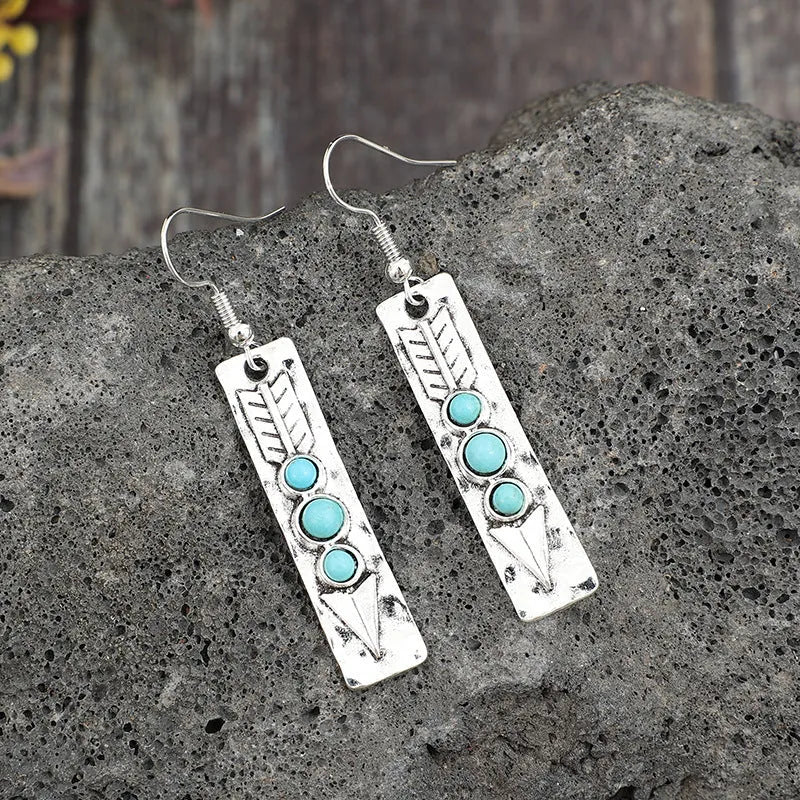 Silver geometric retro earrings with inlaid turquoise detail on zinc alloy