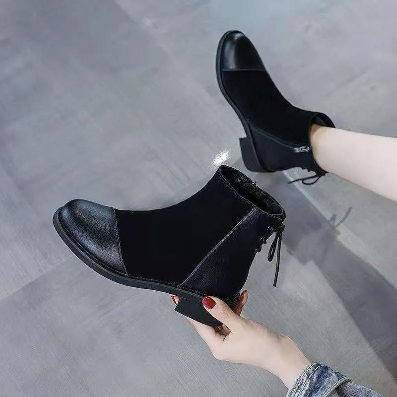 Black women's knee-high Martin boots with side zip, round toe, and chunky heel on a non-slip rubber sole.