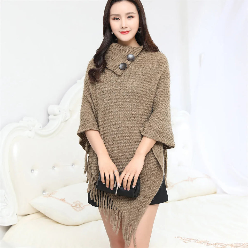 Sleeveless dotted-pattern cloak shawl in acrylic knitwear, shown in apricot colour.