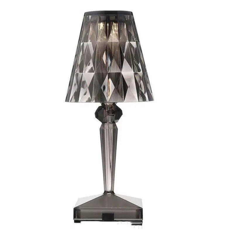Rose gold portable touch projection night light with dimming controls on acrylic base.