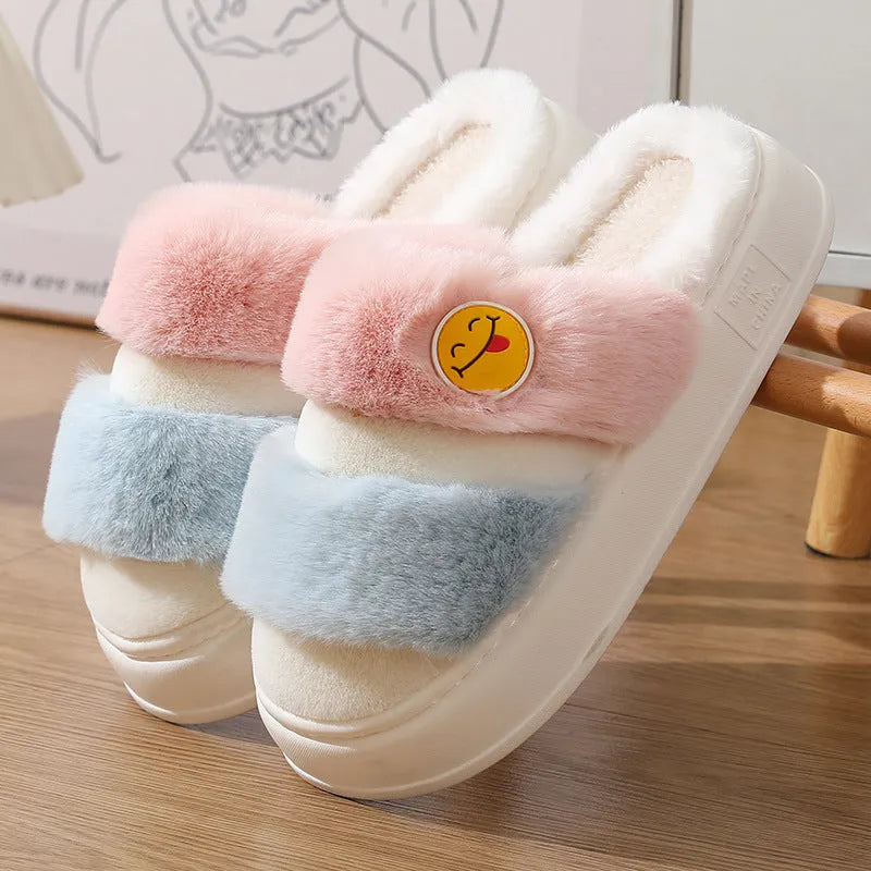 Thermal plush slippers with cashmere lining in pink and green colour block, showing non-slip sole.