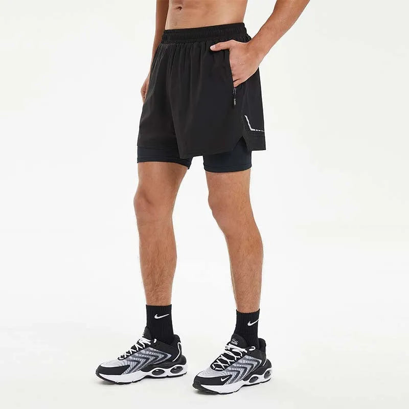 Men's black double-layer running shorts with inner liner on a man running outdoors.