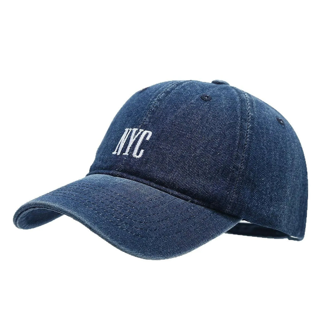 Retro style denim peaked cap with a large alphabet letter on the front, shown in light blue.