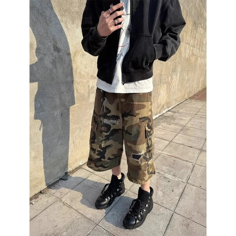 Men's loose-fit camouflage coloured cropped jeans with ripped details and straight-leg cut.
