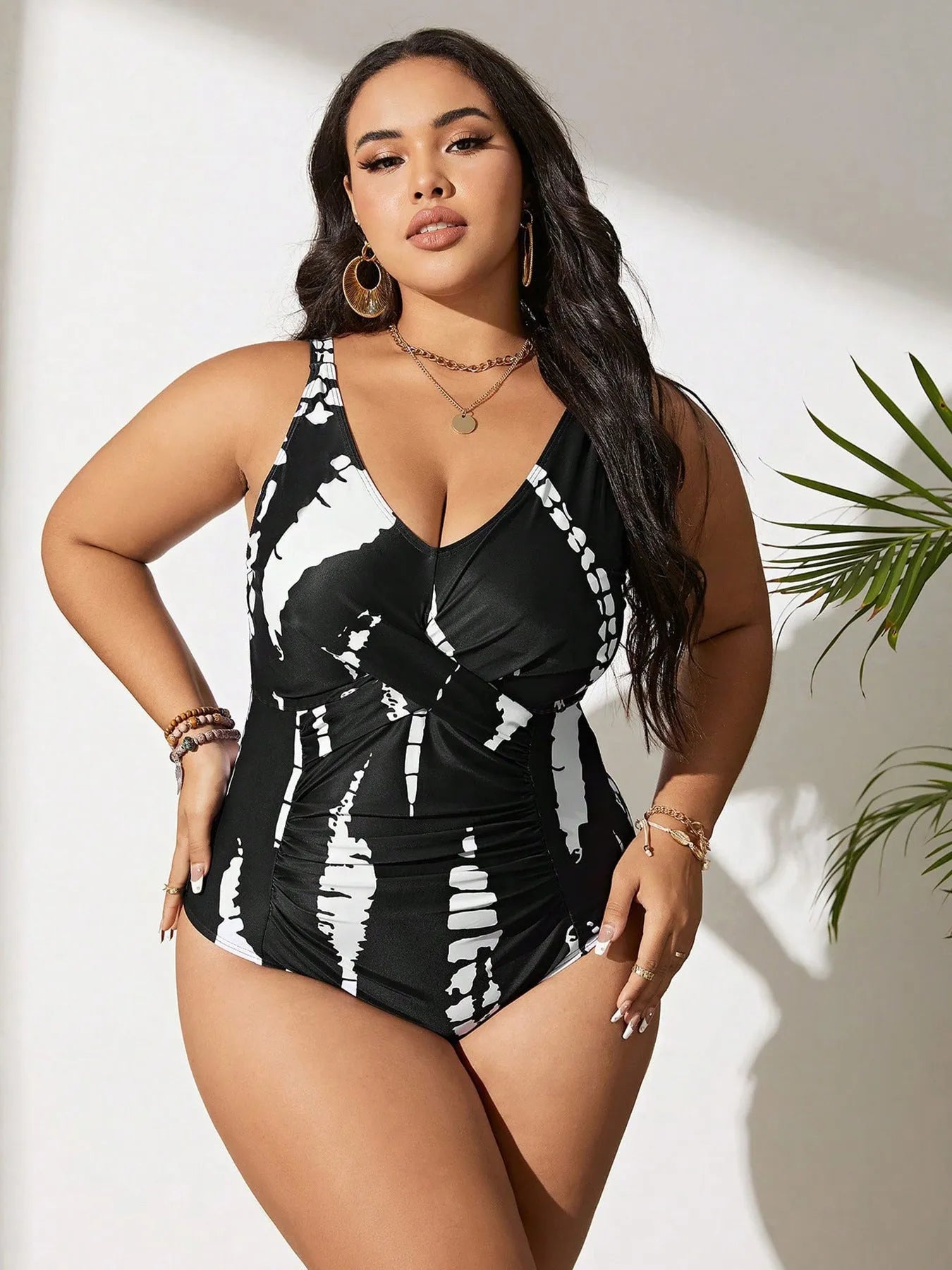 Black Siamese colour matching one-piece swimsuit on a hanger, showing sleeveless design.