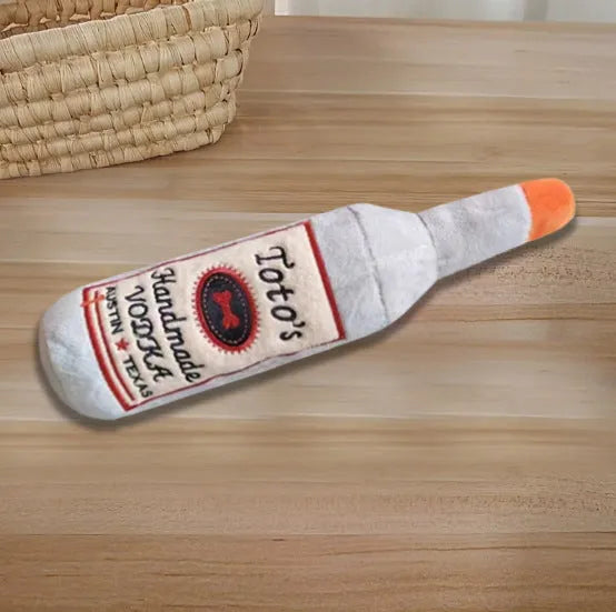Brown plush wine bottle shaped dog toy with squeaker for chewing and play