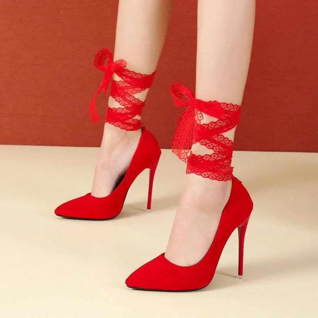 Women's black pointed toe high heel with a lace strap and flat buckle.