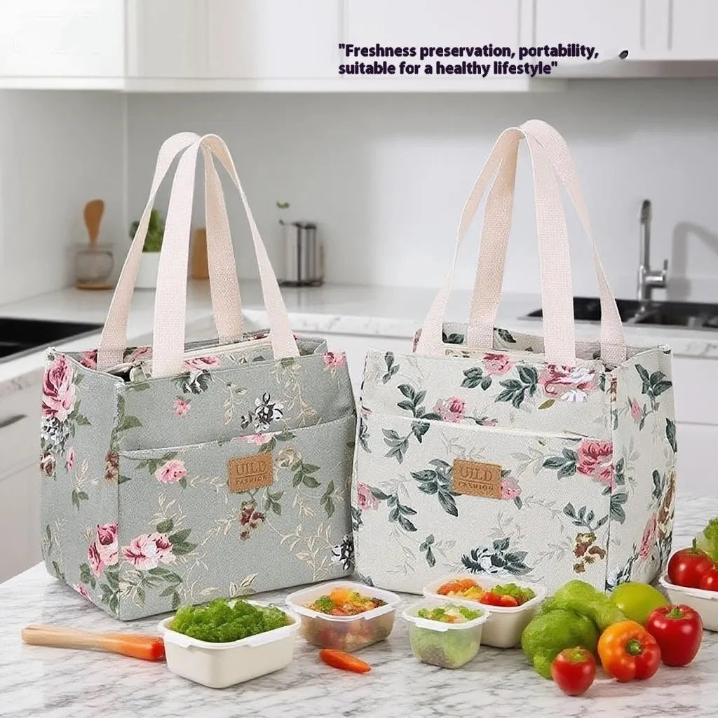 Women's printed canvas handbag with aluminium frame in a horizontal square shape, shown in a floral design.