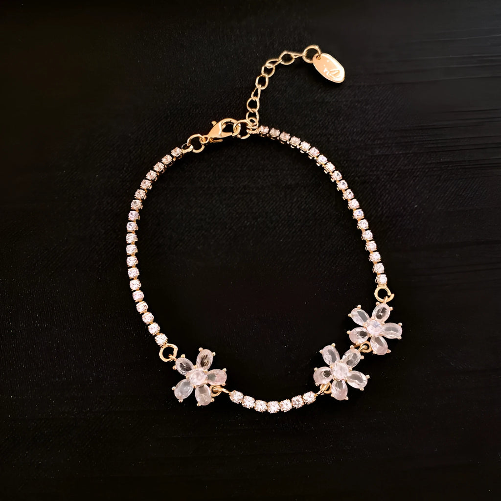 Gold-coloured geometric copper bracelet with inlaid zircon stones in quadrilateral pattern