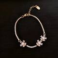 Gold-coloured geometric copper bracelet with inlaid zircon stones in quadrilateral pattern