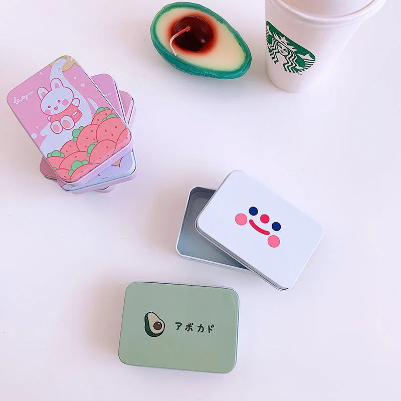 Small decorative iron storage tin box with a colourful printed lid, shown closed.
